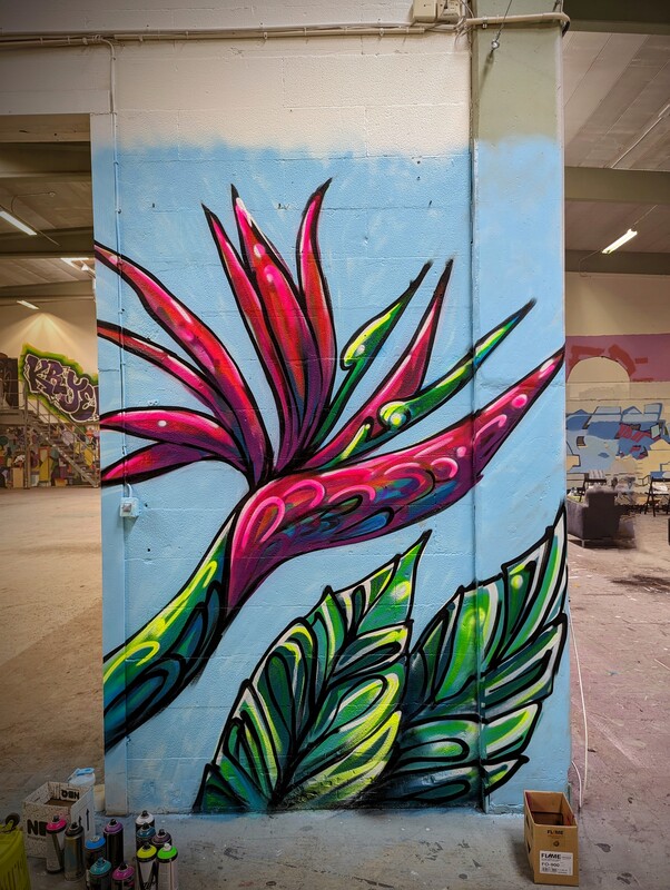 Bird of paradise mural in studio with spray cans